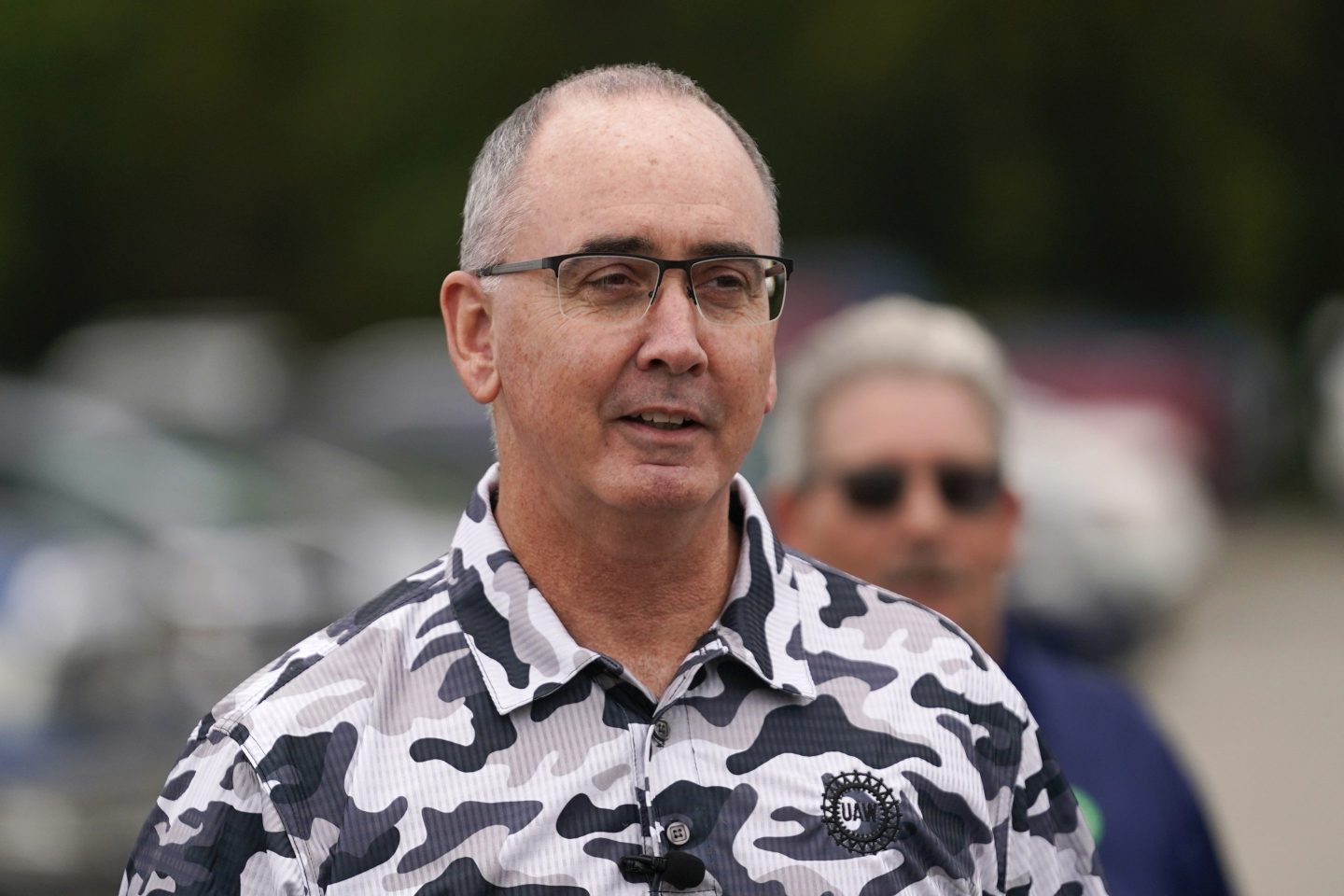 United Auto Workers President Shawn Fain talks with members picketing near a General Motors Assembly Plant in Delta Township, Mich., on Sept. 29, 2023.