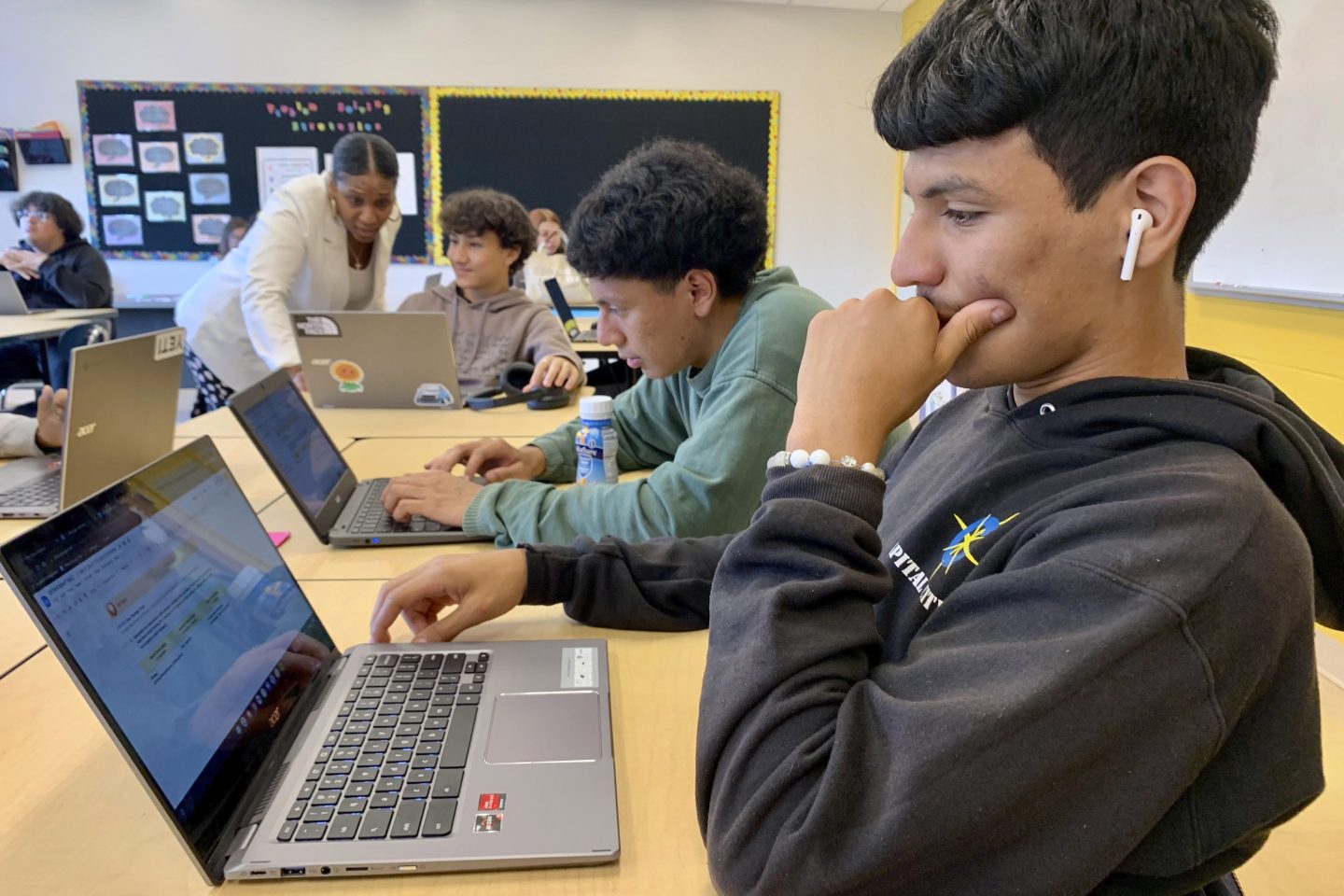 A student working on a laptop in a classroom