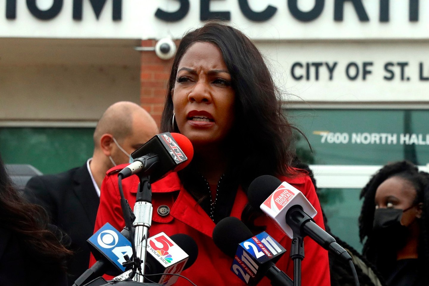 St. Louis Mayor Tishaura Jones wearing a red coat while speaking to the press.
