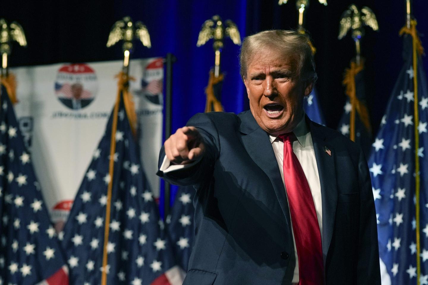 Donald Trump pointing while speaking at a rally.