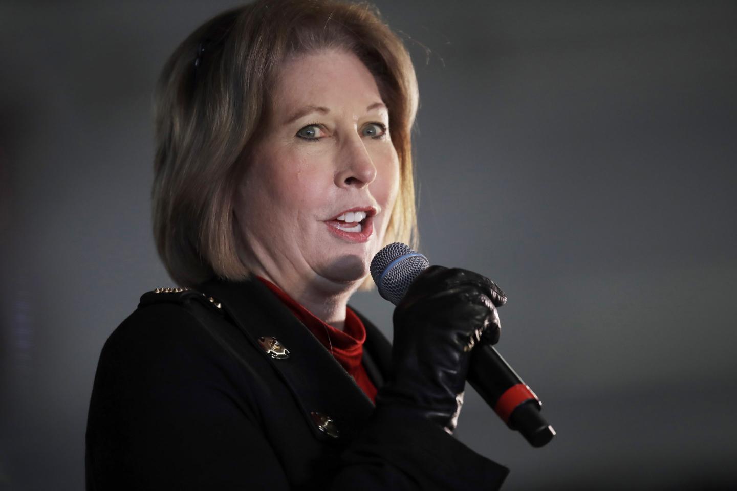 Sidney Powell speaking into a microphone