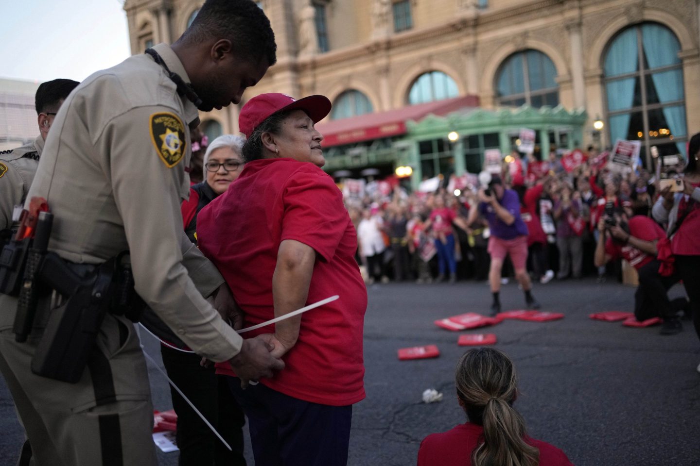 A Las Vegas police officer arrests a member of the Culinary Workers Union along the Strip, on Oct. 25, 2023, in Las Vegas. 
