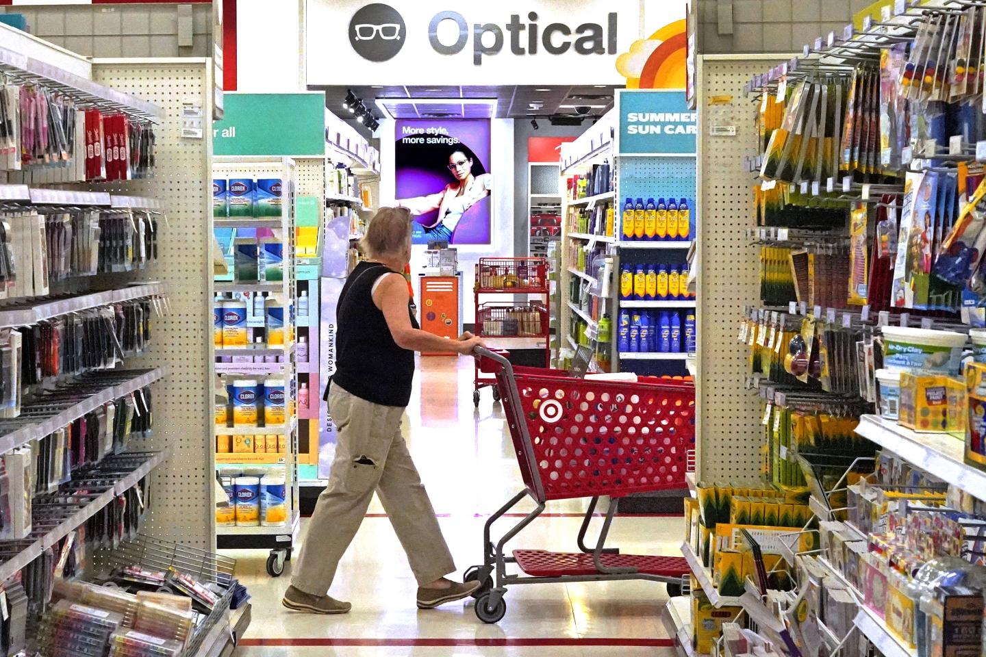 Woman shopping in a Target store pushing a red cart