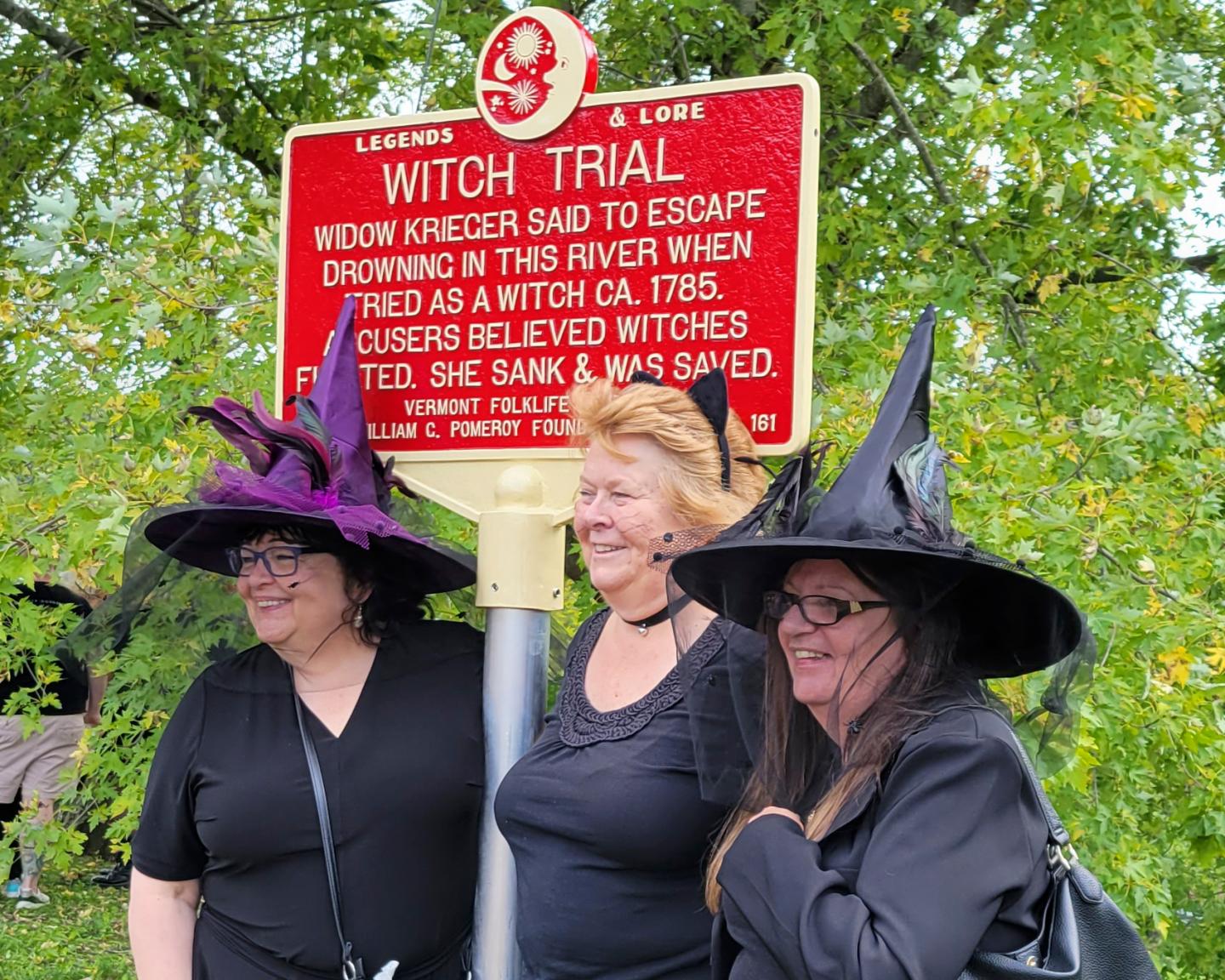 People dressed as witches gather near a newly installed marker, in Pownal, Vt., that recognizes the survivor of Vermont's only recorded witch trial.