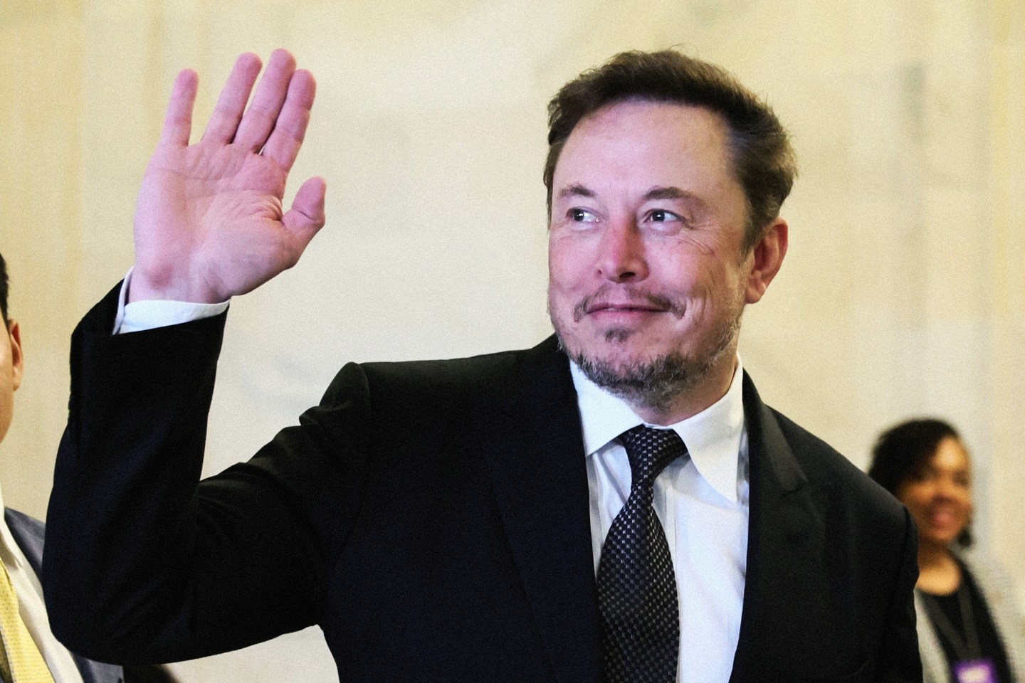 Elon Musk waves as he arrives for a bipartisan Artificial Intelligence (AI) Insight Forum for all U.S. senators.