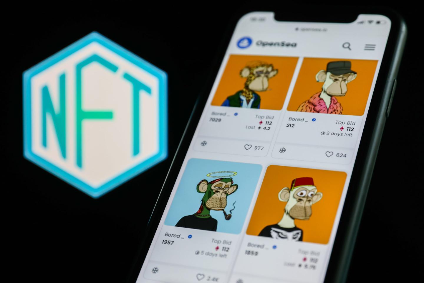 iphone displaying colorful NFTs depicting cartoon apes