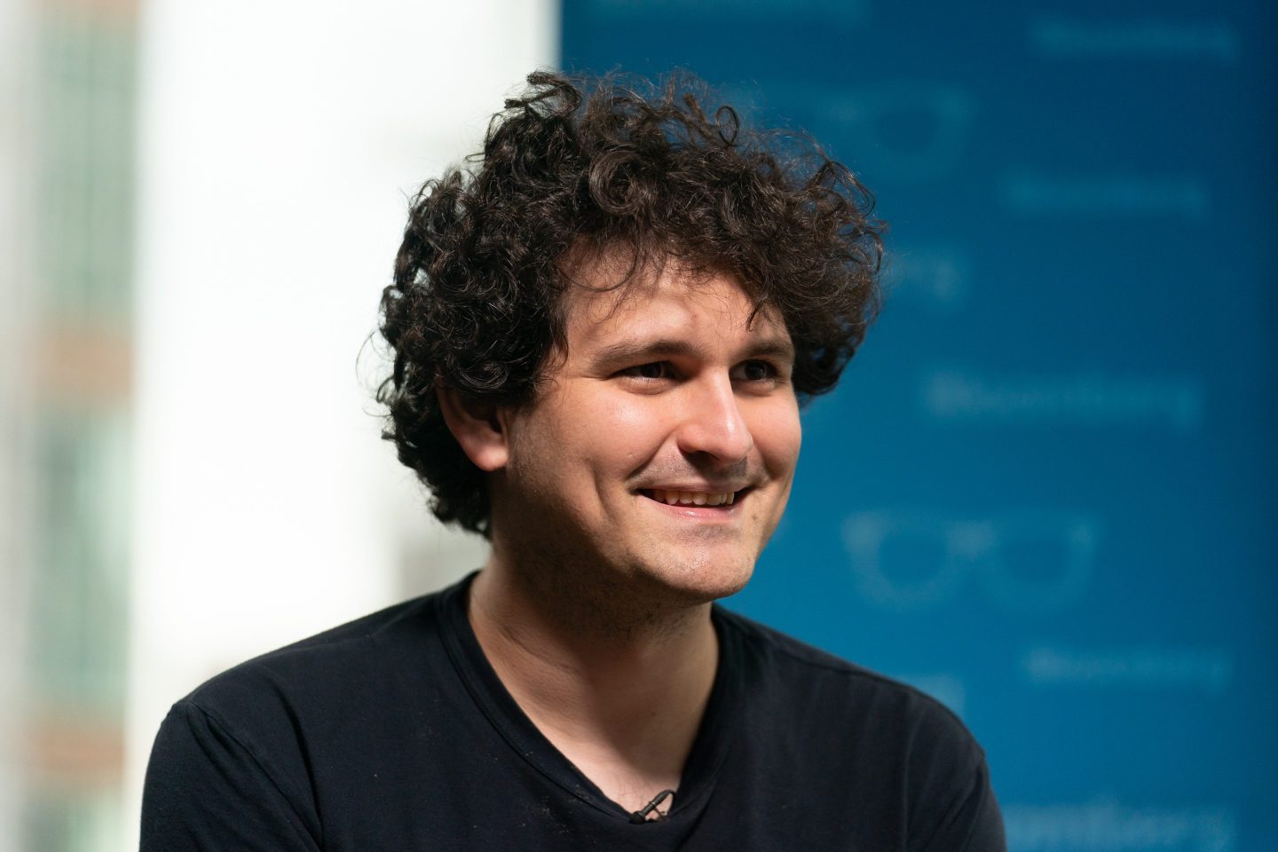 Sam Bankman-Fried smiles during an interview.