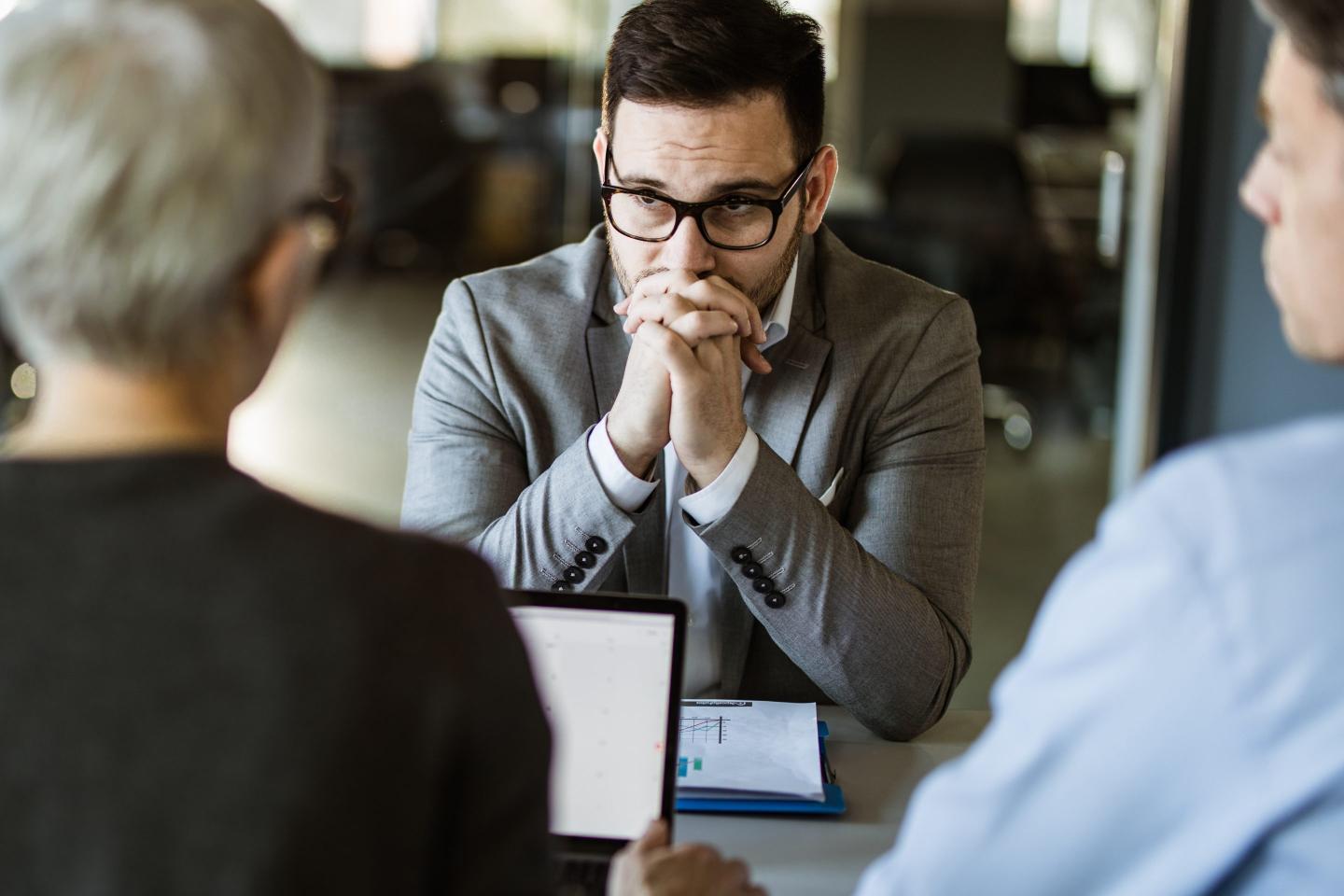 Worried businessman during a meeting with his colleagues in the office.