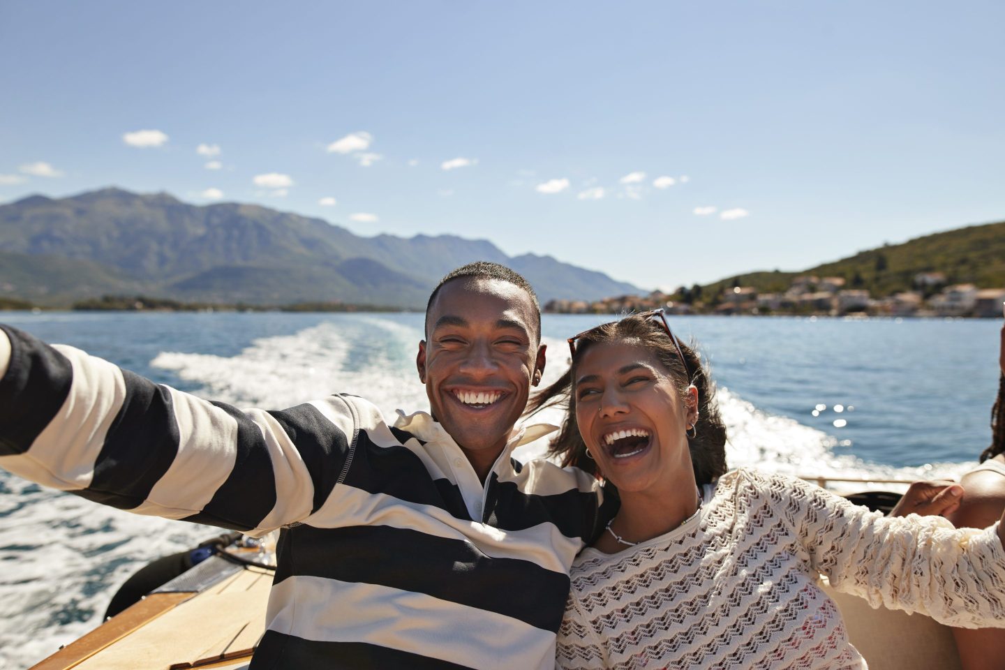 Smiling young couple taking a selfie in a boat