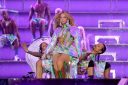 Beyoncé onstage during the opening night of the Renaissance World Tour wearing a holographic dress and jacket.