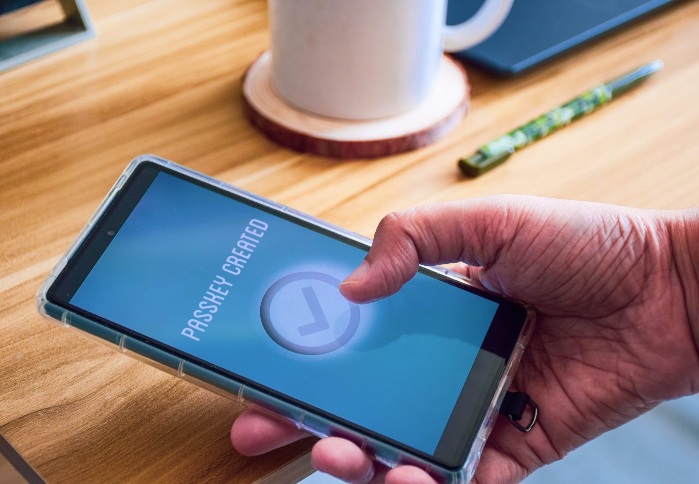 Person holding phone with a multi-factor authentication sign-in process on the screen.