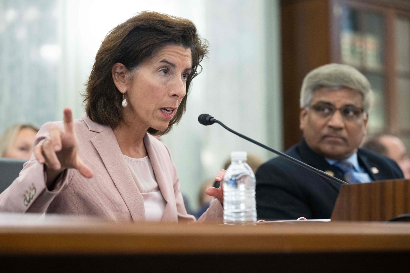 U.S. Commerce Secretary Gina Raimondo speaks into a microphone during a U.S. Senate hearing