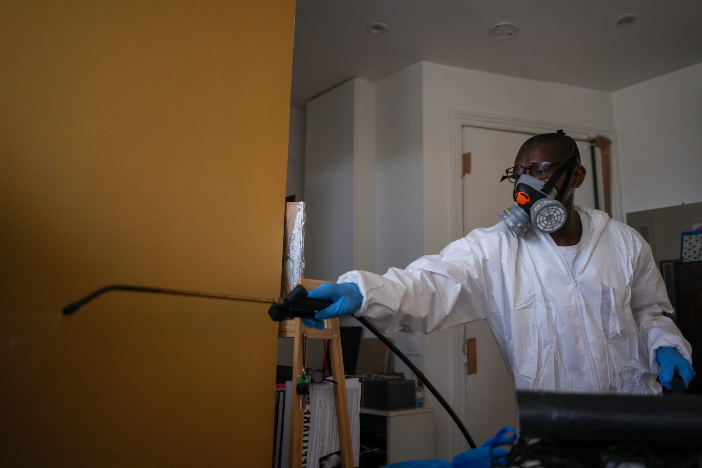 A pest control worker sprays a bedbug-killing chemical in Paris