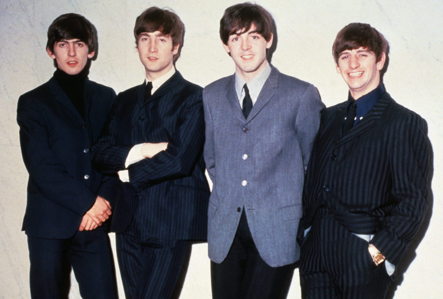 The Beatles posing together.