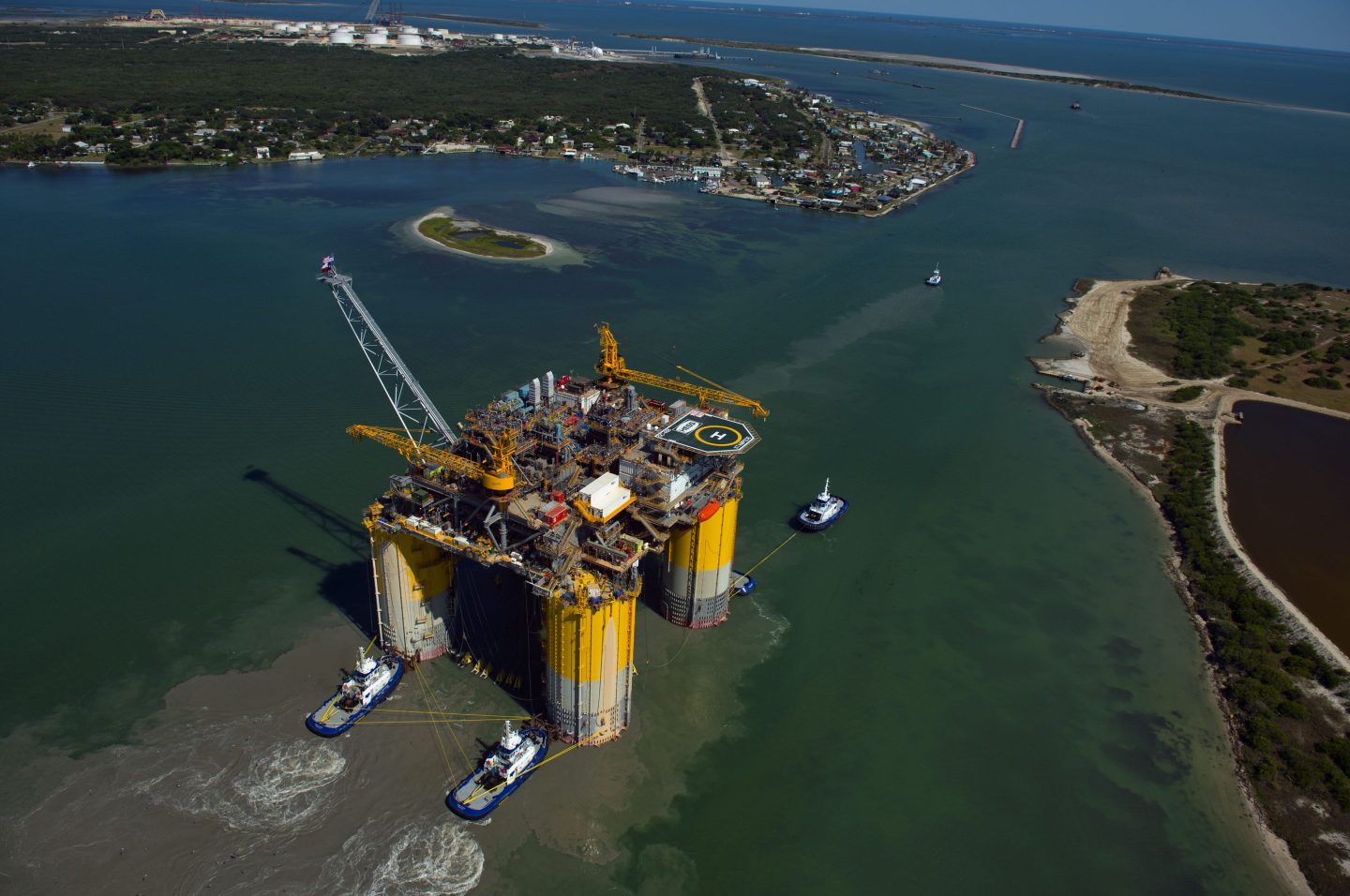 Tug boats transport the Hess Corp. Stampede tension leg oil platform, towed from Kiewit Offshore Services, in this aerial photograph taken above Ingleside, Texas on May 5, 2017.