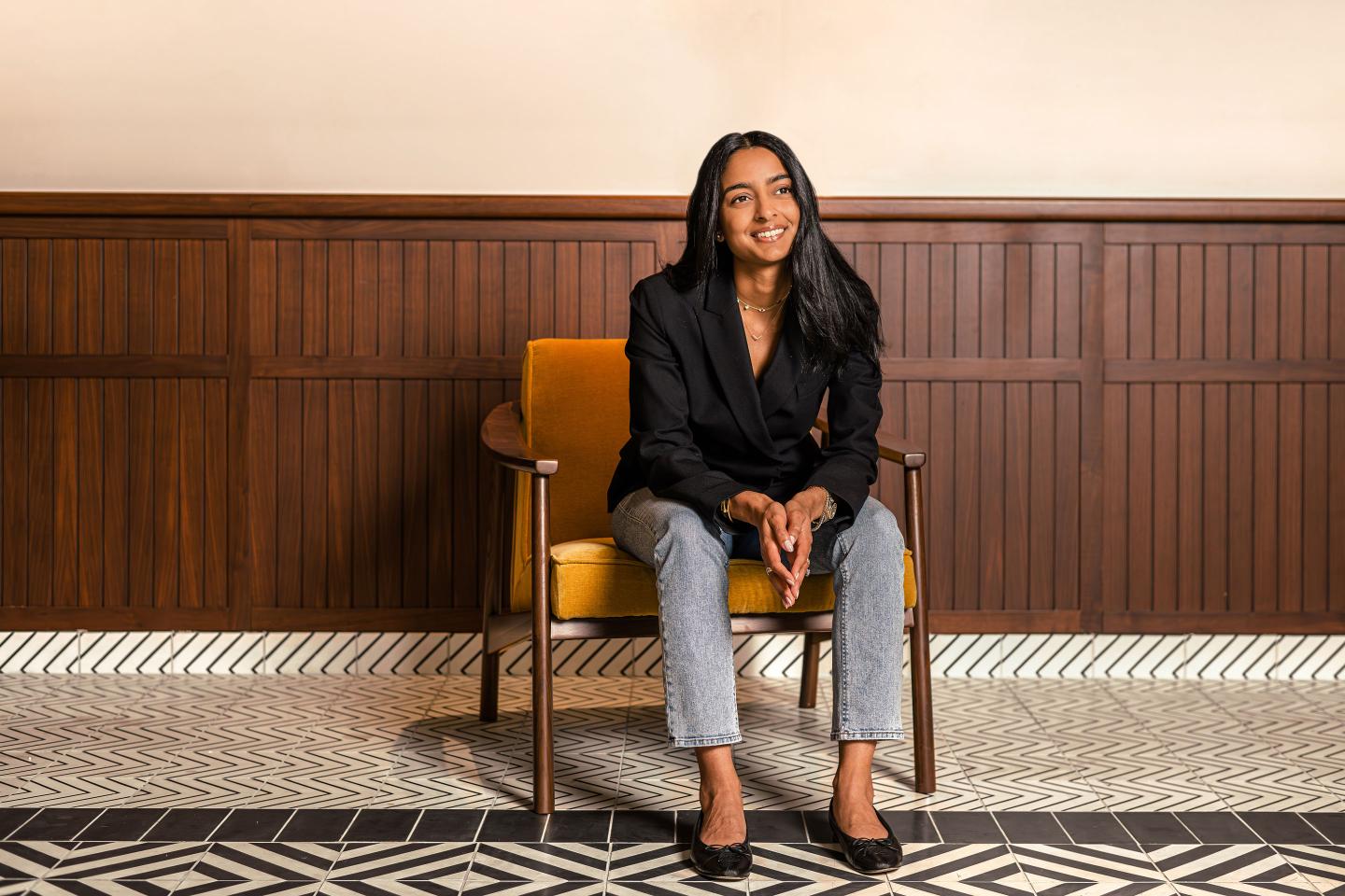 businesswoman sitting in a chair, posed for a portrait