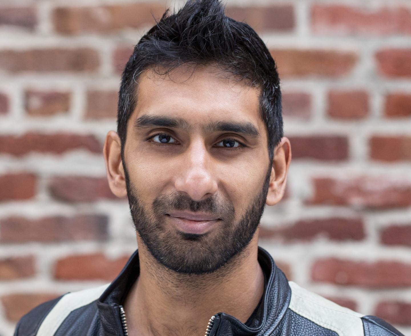 portrait of businessman in front of brick wall