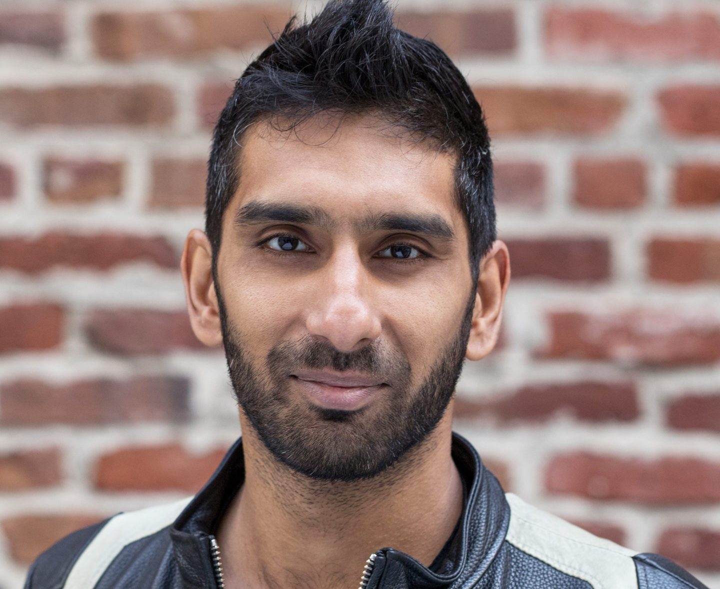 portrait of businessman in front of brick wall