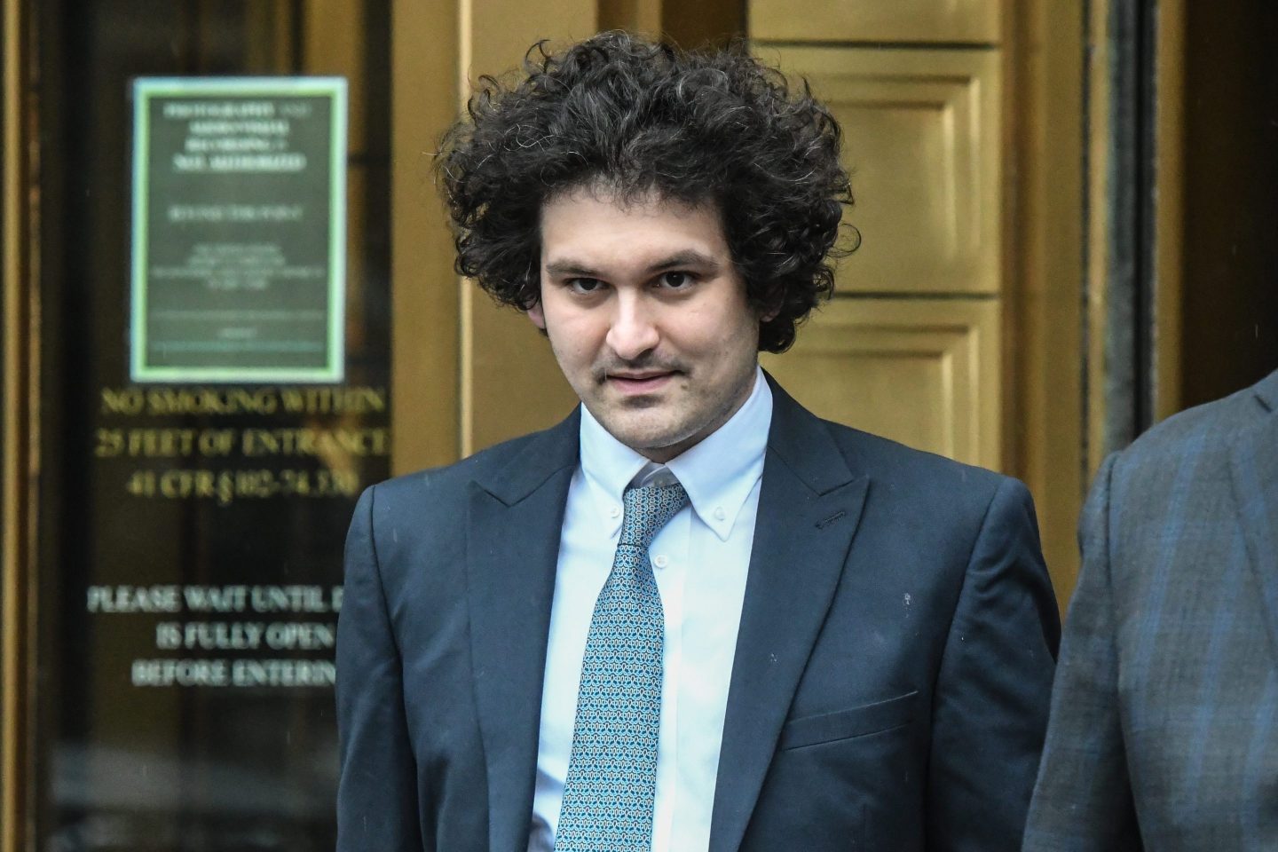 man in suit and tie leaving court