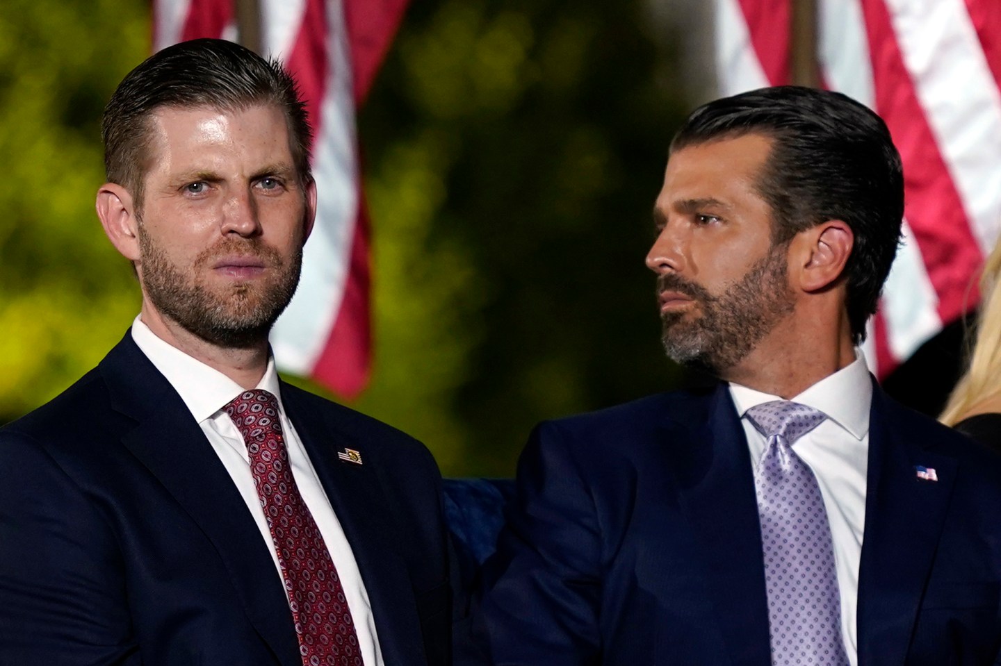 Eric Trump and Donald Trump Jr., wait for President Donald Trump to speak from the South Lawn of the White House