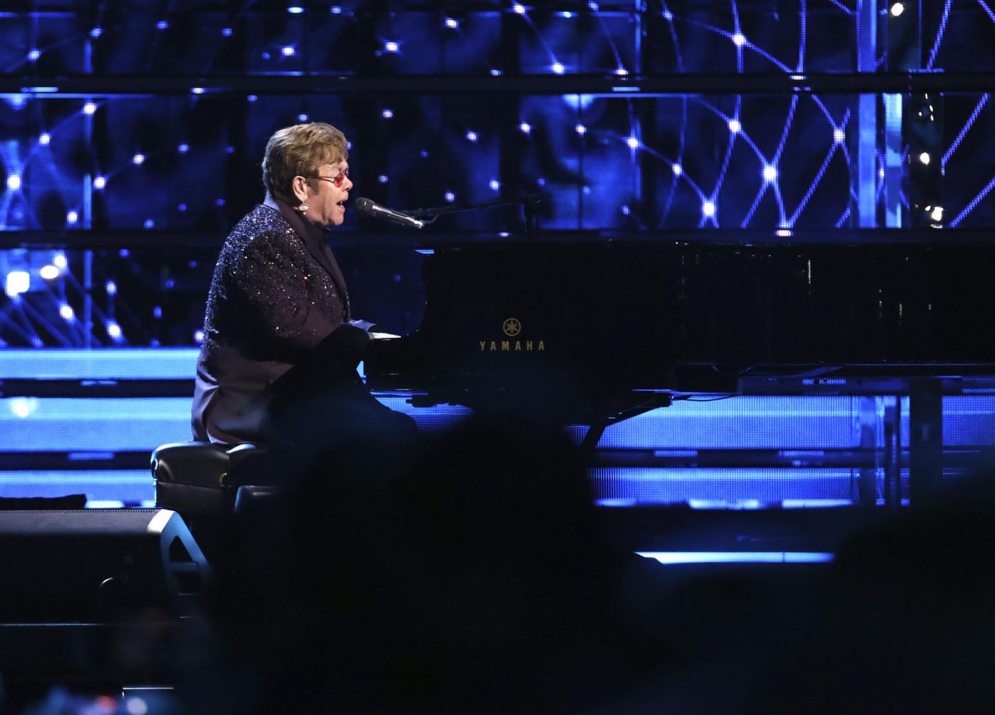 Elton John performing on stage