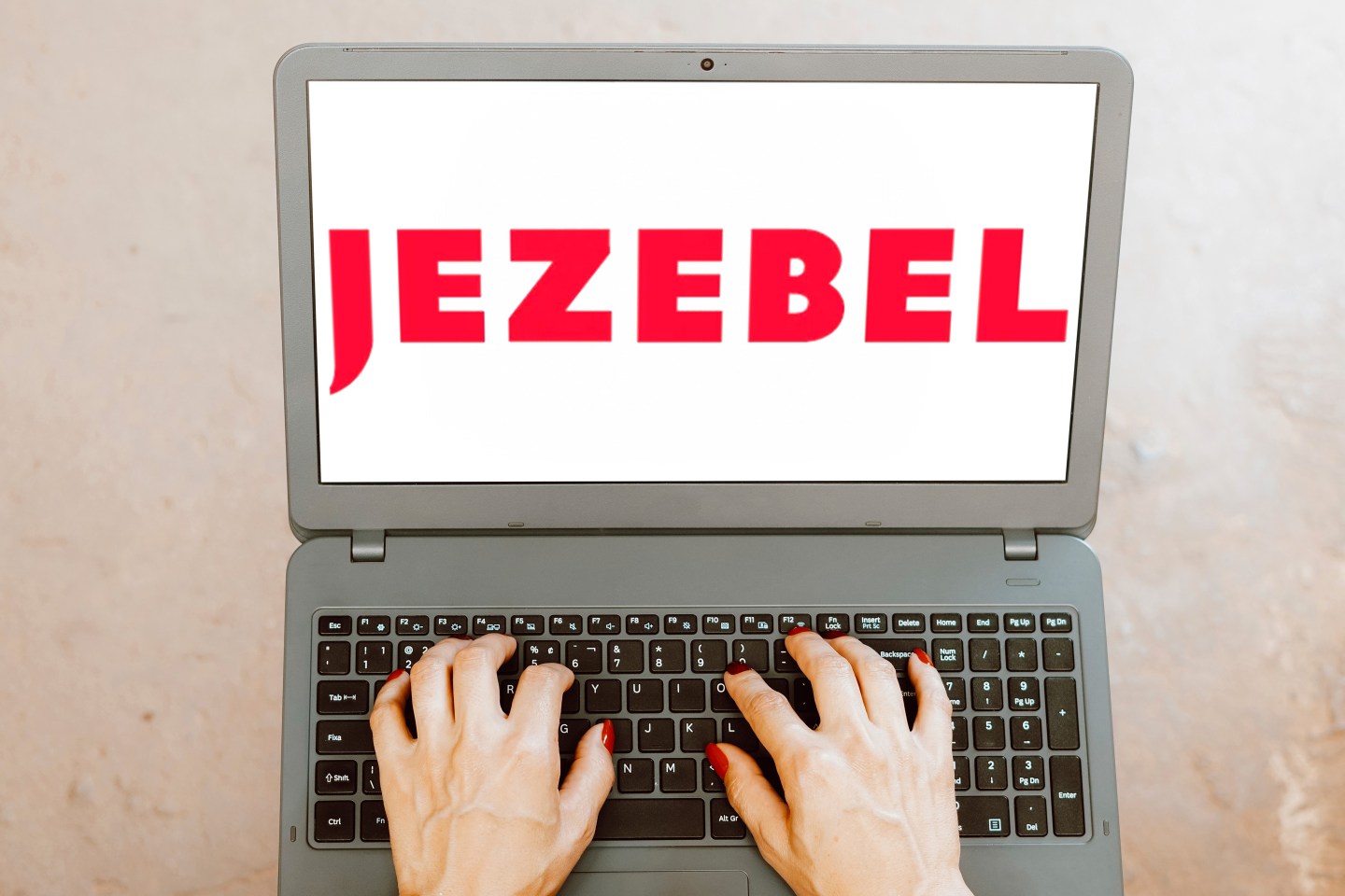 Jezebel logo is displayed on a laptop screen