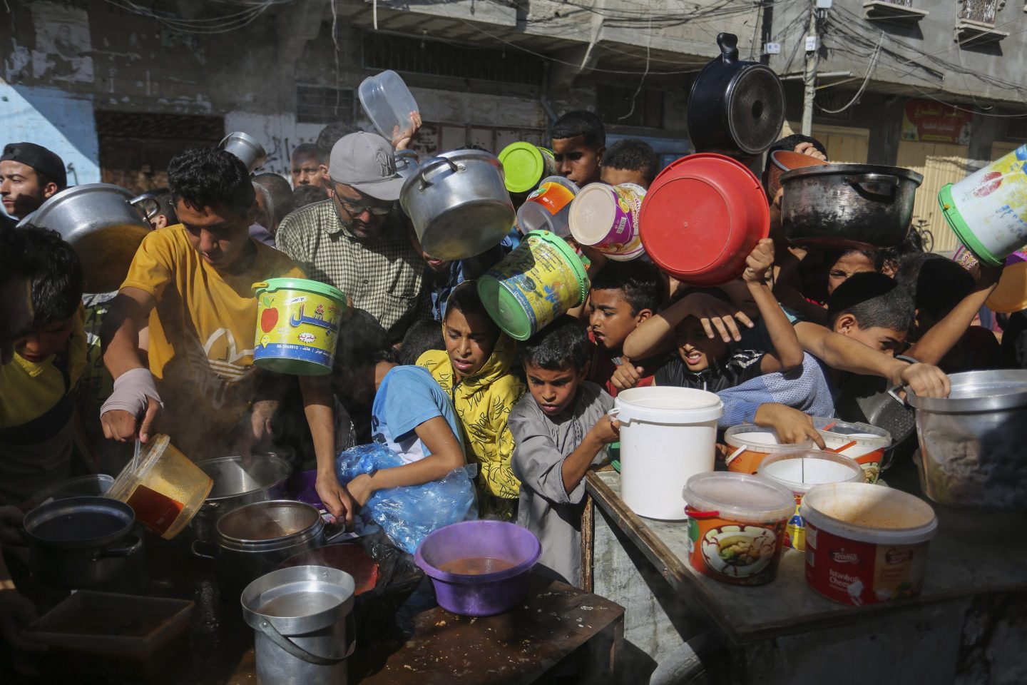 Palestinians crowded together as they wait for food distribution
