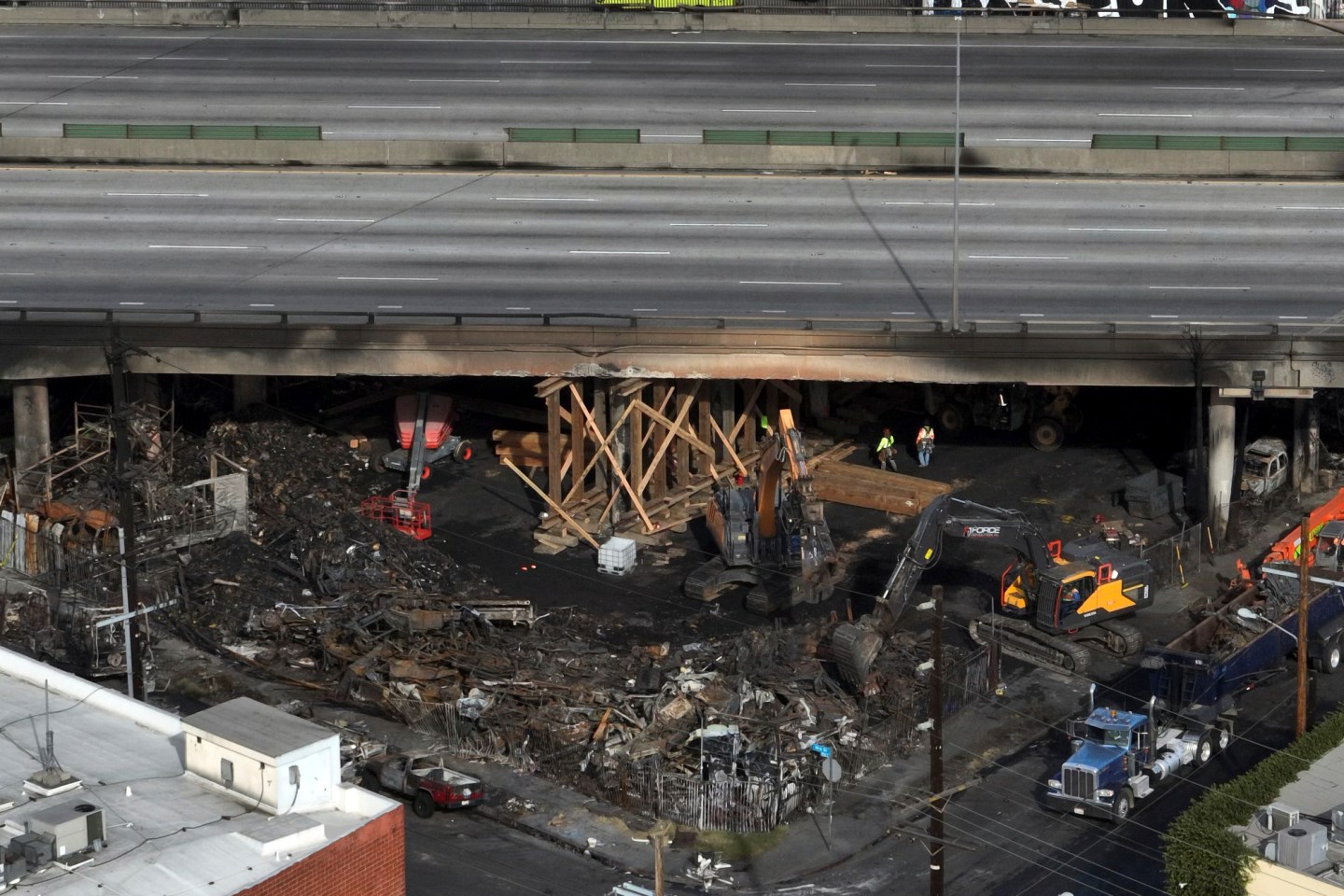 The site of a fire is shown under Interstate 10 in Los Angeles