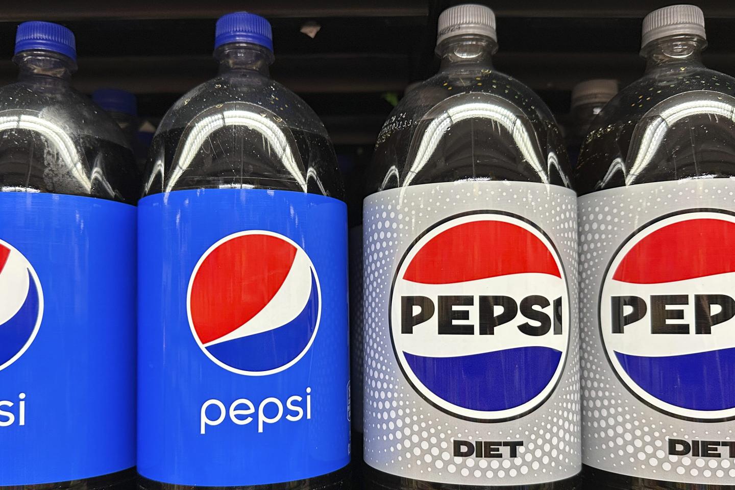 Pepsi soft drinks in plastic bottles are on sale at a grocery store