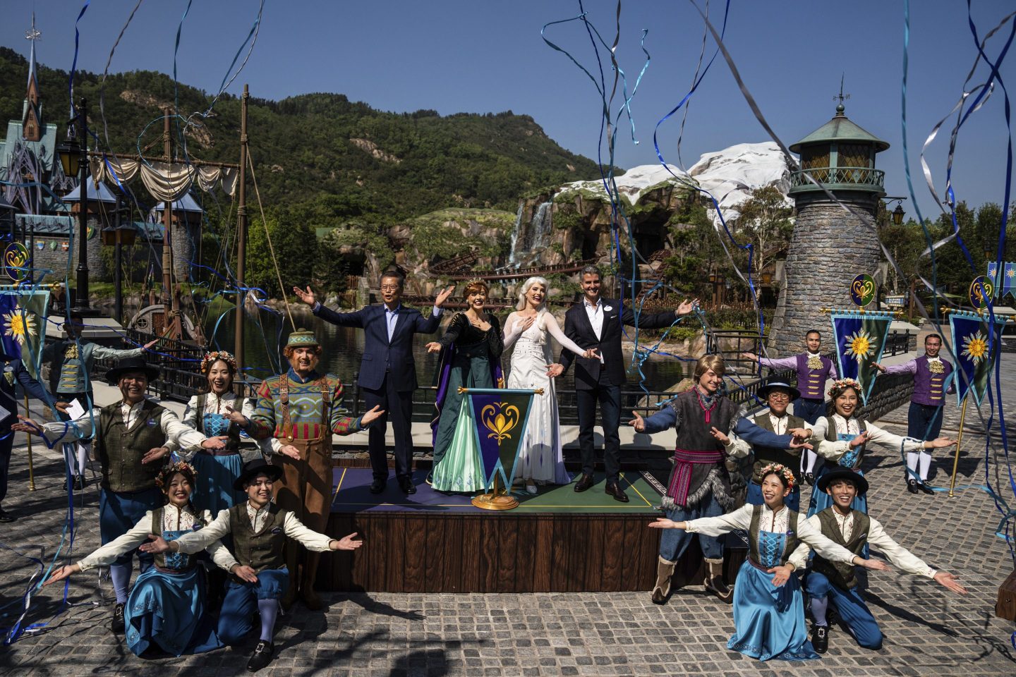Paul Chan, Hong Kong's financial secretary, left, and Josh D'Amaro, chairperson of Disney Experiences, right, pose with performers in front of the press during the opening ceremony of the World of Frozen themed area at Disneyland Resort in Hong Kong on, Nov. 20, 2023.