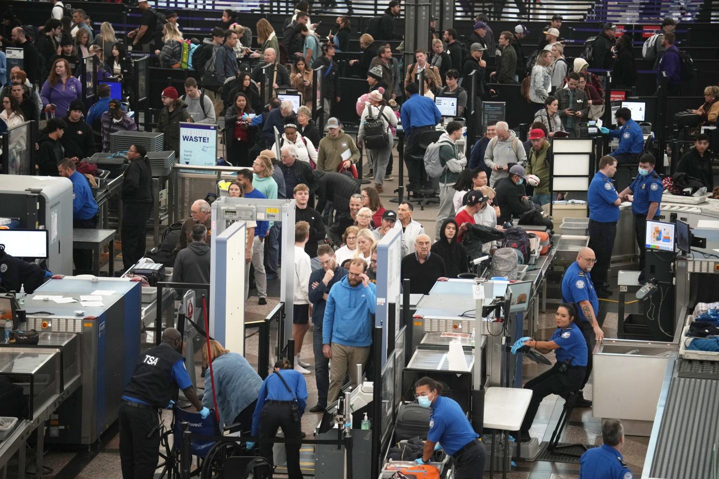 Travellers queue up to pass through the south security checkpoint at Denver International Airport