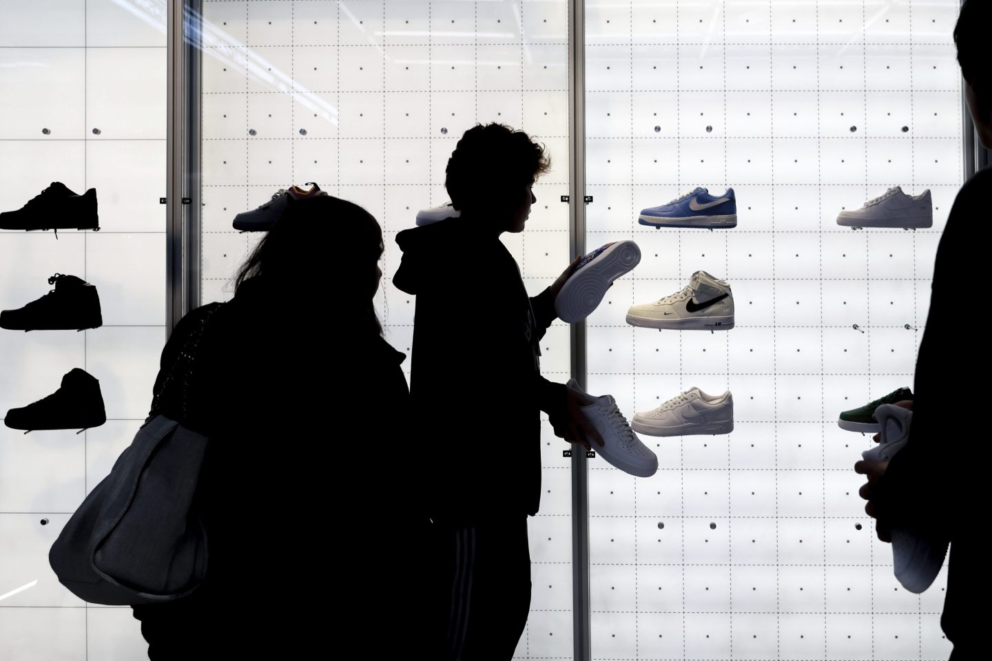 People shop for Nike shoes at a store on Nov. 25, 2022, in New York.