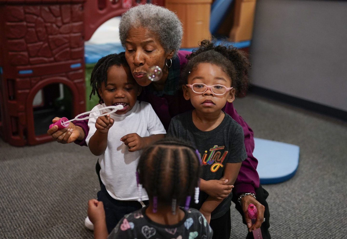 Toddler teacher Janice Bradley blows bubbles with a toddler group at the Life Learning Center - Head Start, in Cincinnati, on Nov. 21, 2023.