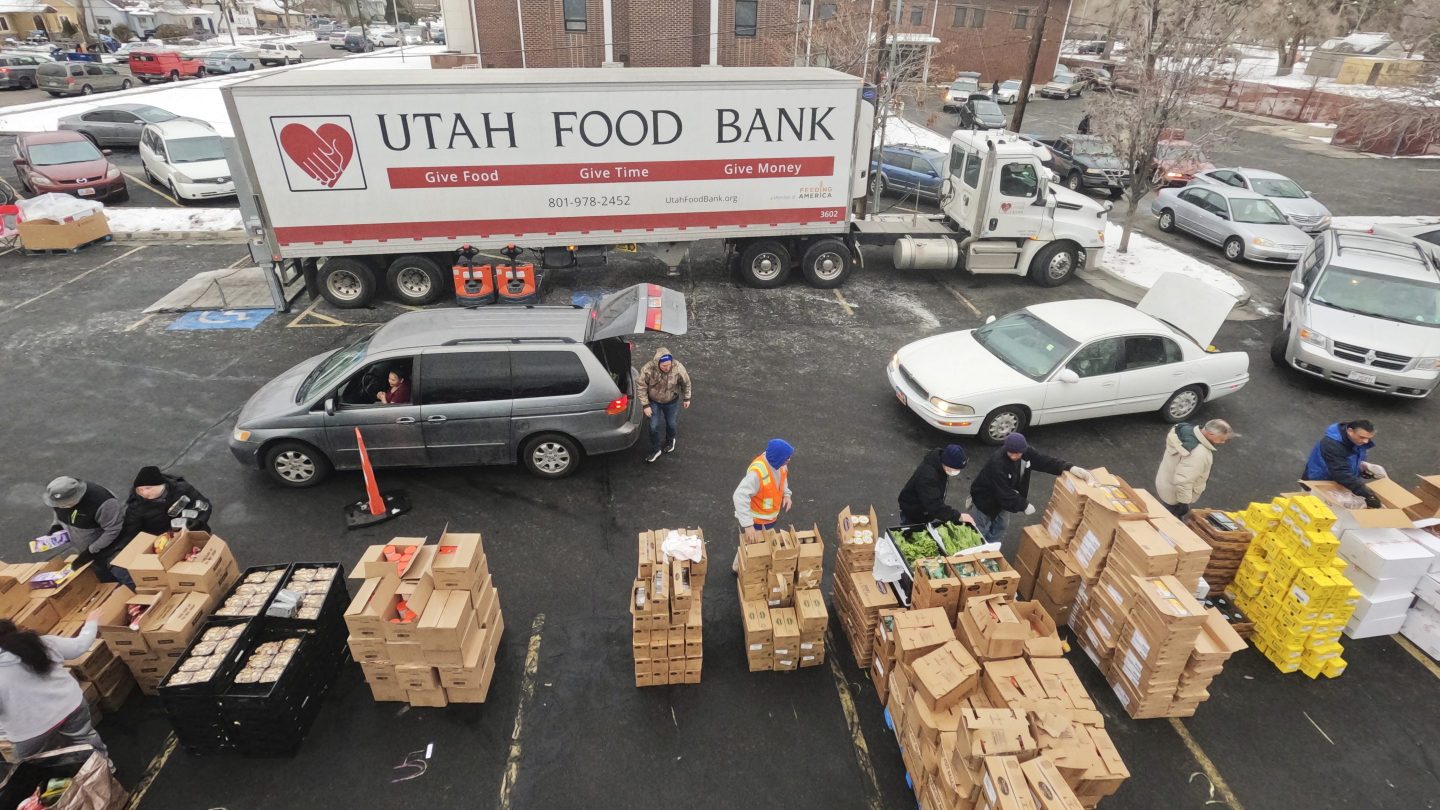 Utah Food Bank volunteers load groceries for the needy at a mobile food pantry distribution site Wednesday, Dec. 21, 2022, in Salt Lake City.