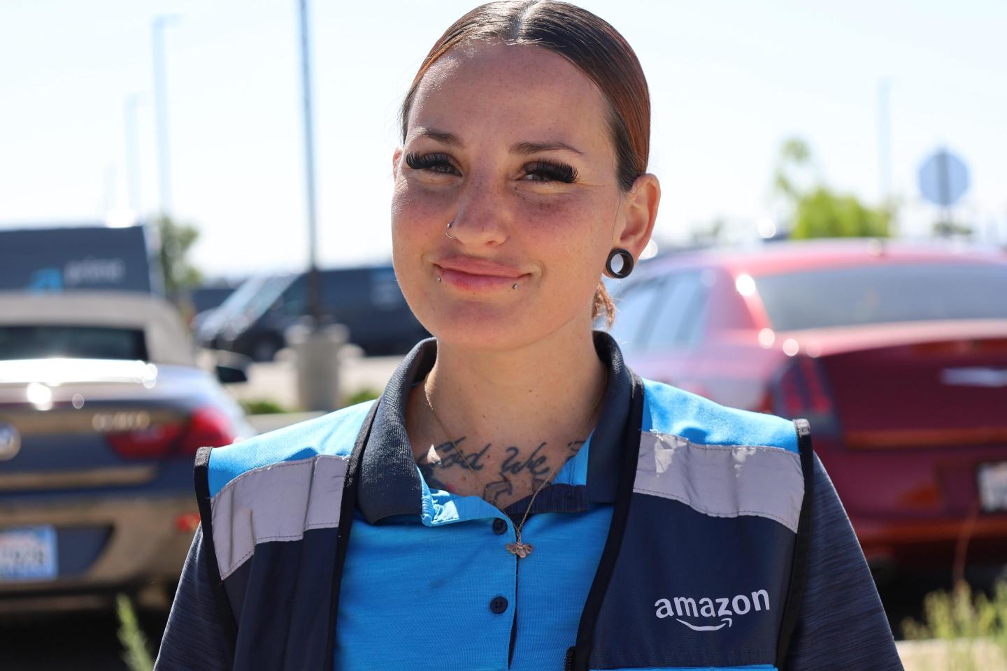 A smiling woman wearing an Amazon jacket
