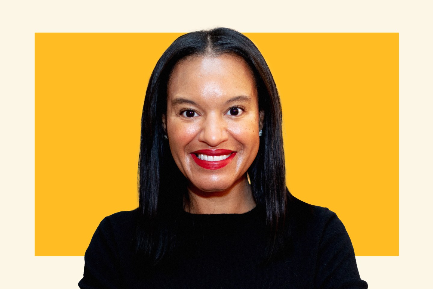 Portrait of e.l.f. Beauty CFO Mandy Fields smiling on an orange background.