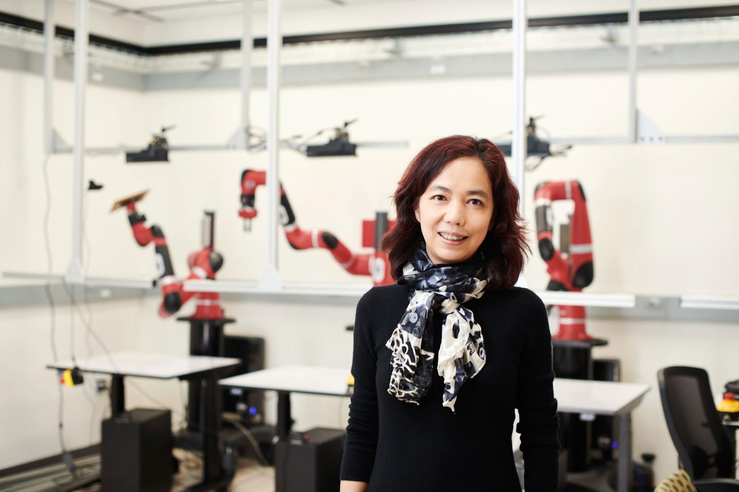 Fei-Fei Li posing for a photo in a university lab