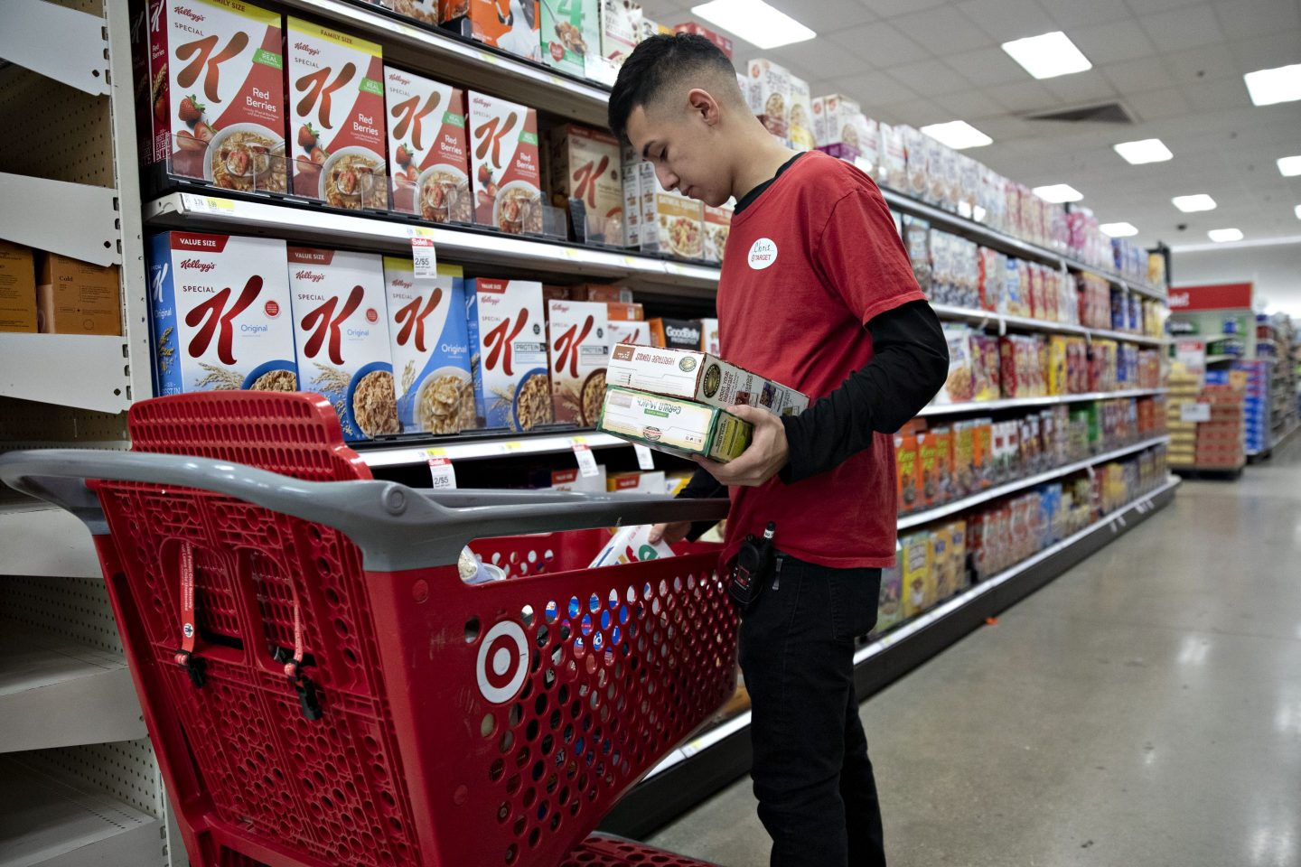 A Target employee stocking shelves