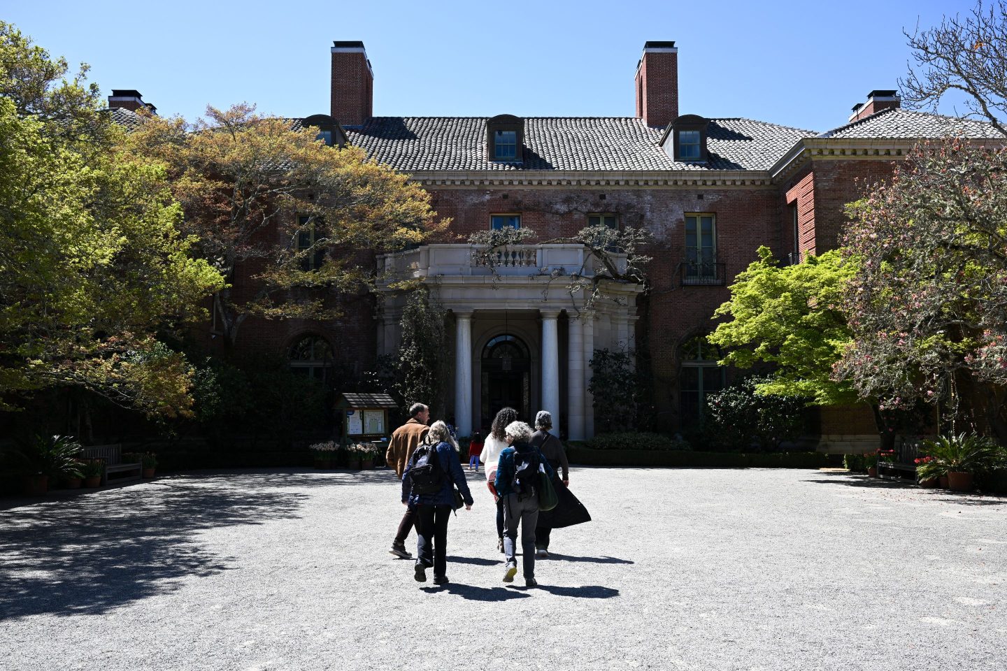 Visitors are seen as trees blossom at Filoli Historic House & Garden.