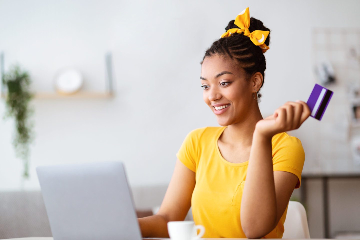 Photo of young woman shopping on her laptop