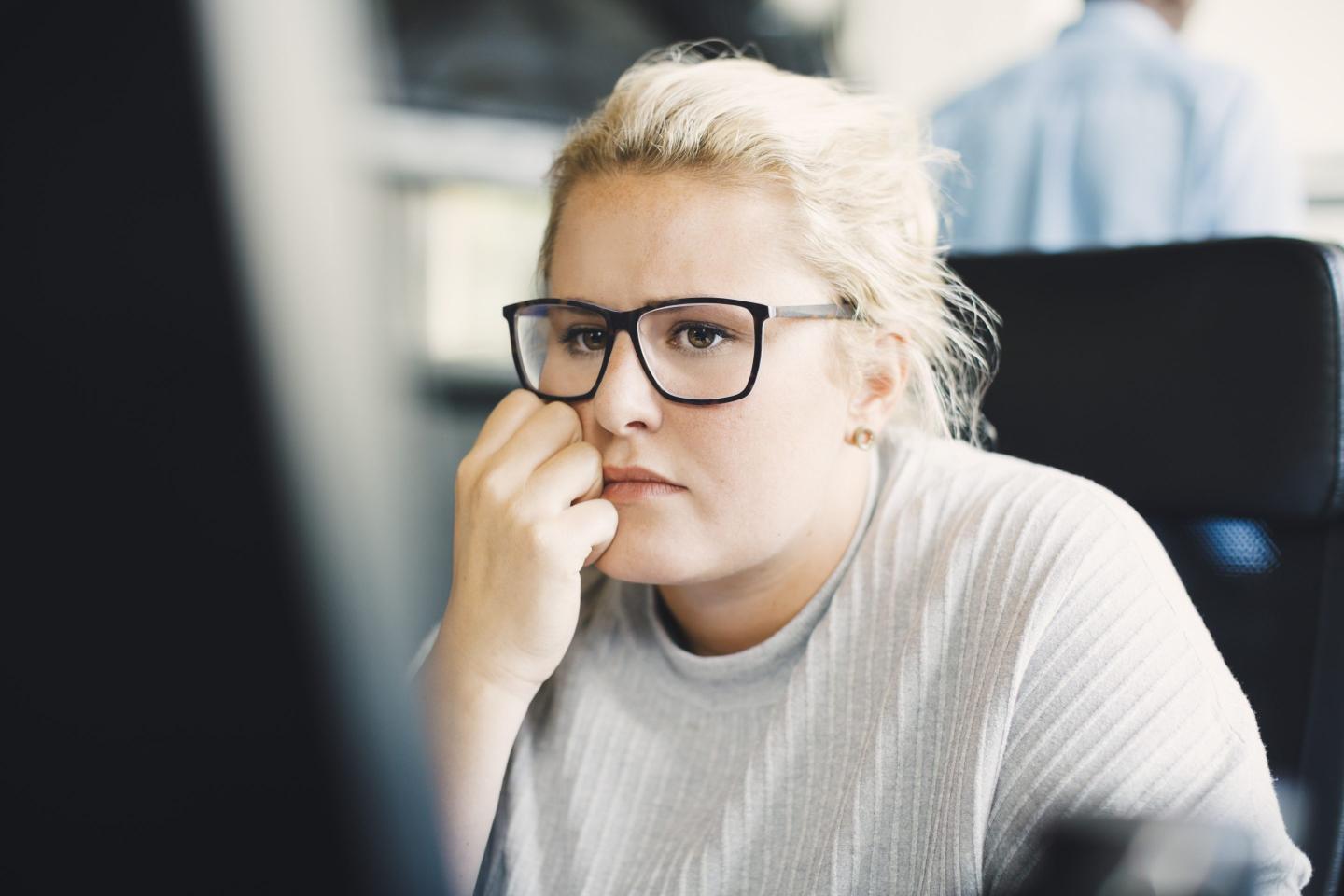 Blond businesswoman working on computer at office