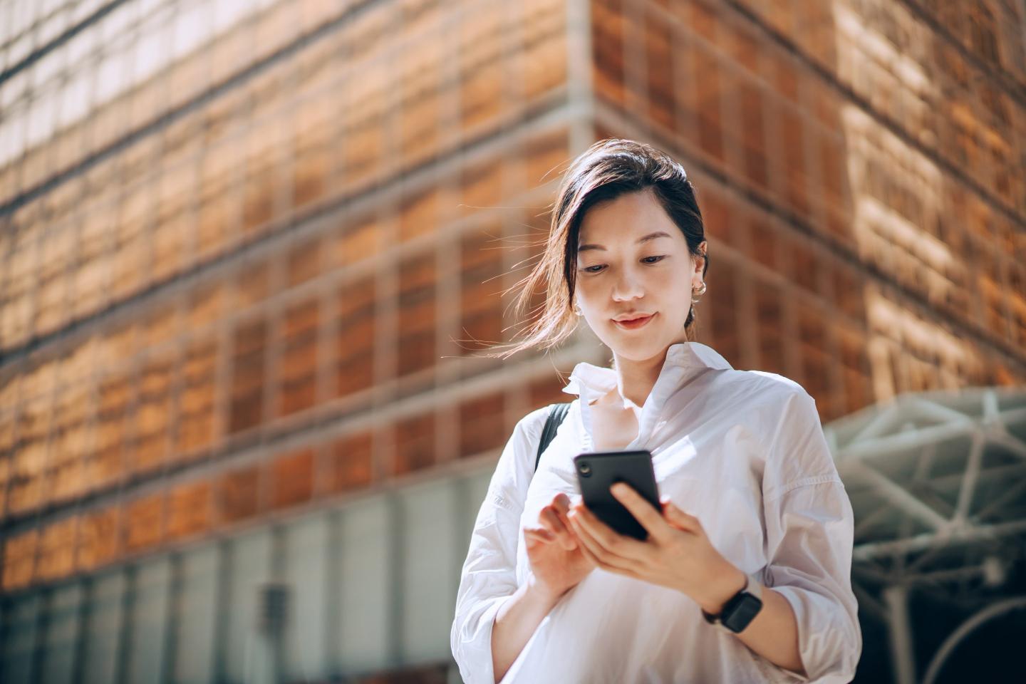 Asian businesswoman checking her phone