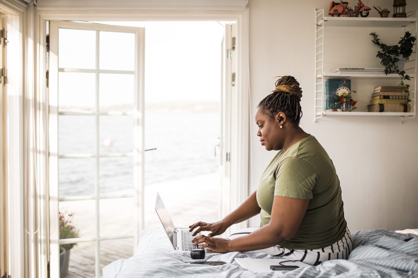 Businesswoman working remotely on laptop in cottage