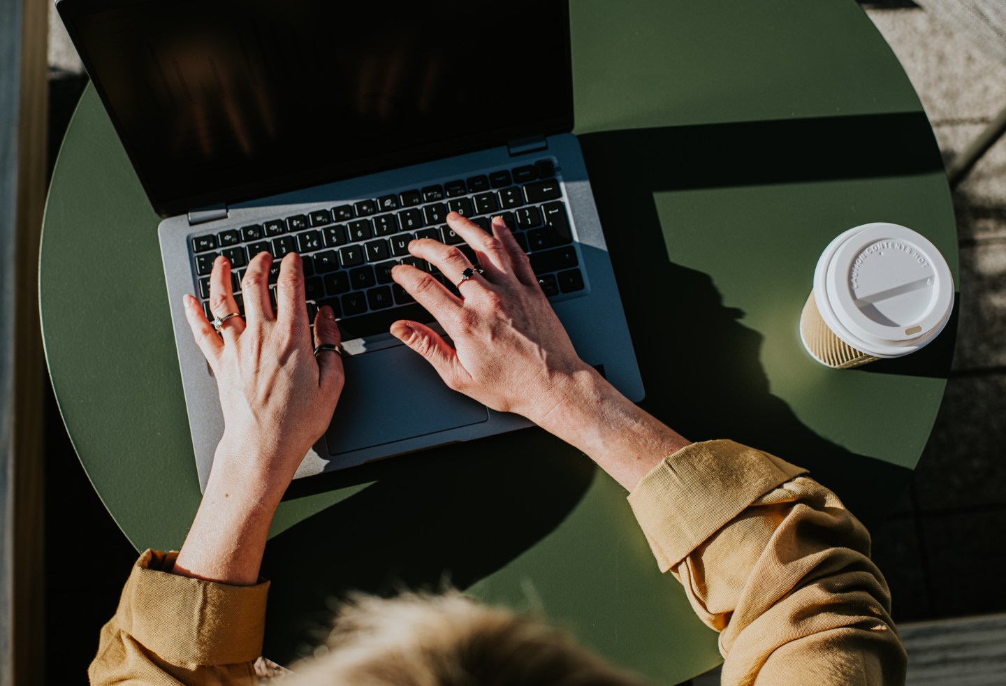 hands typing on a laptop keyboard
