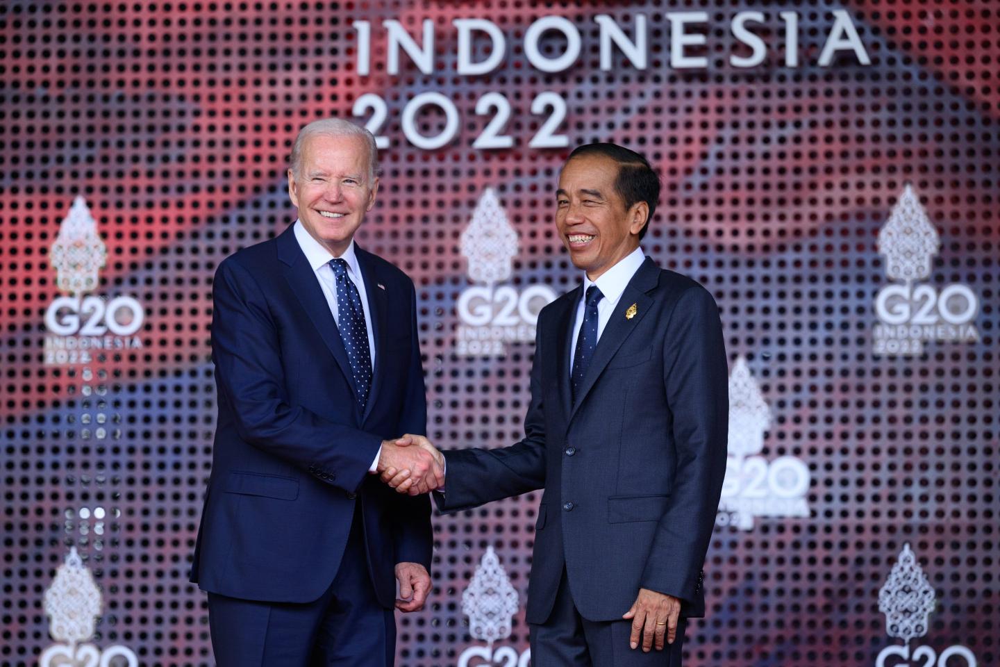 U.S. President Joe Biden and Indonesian President Joko Widodo shake hands