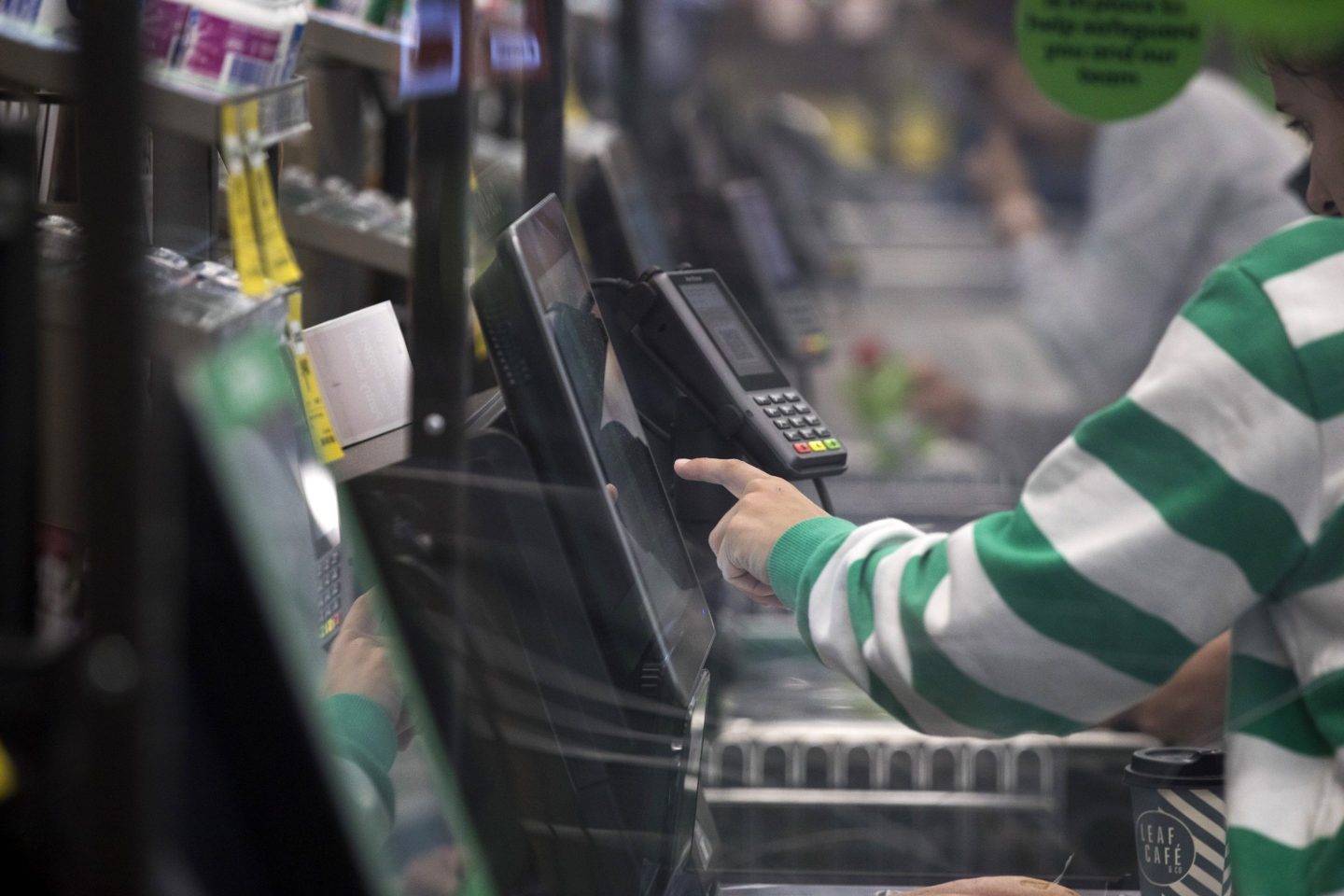 A customer at a self-service checkout kiosk at a Woolworths Group Ltd. grocery store in Sydney, Australia.