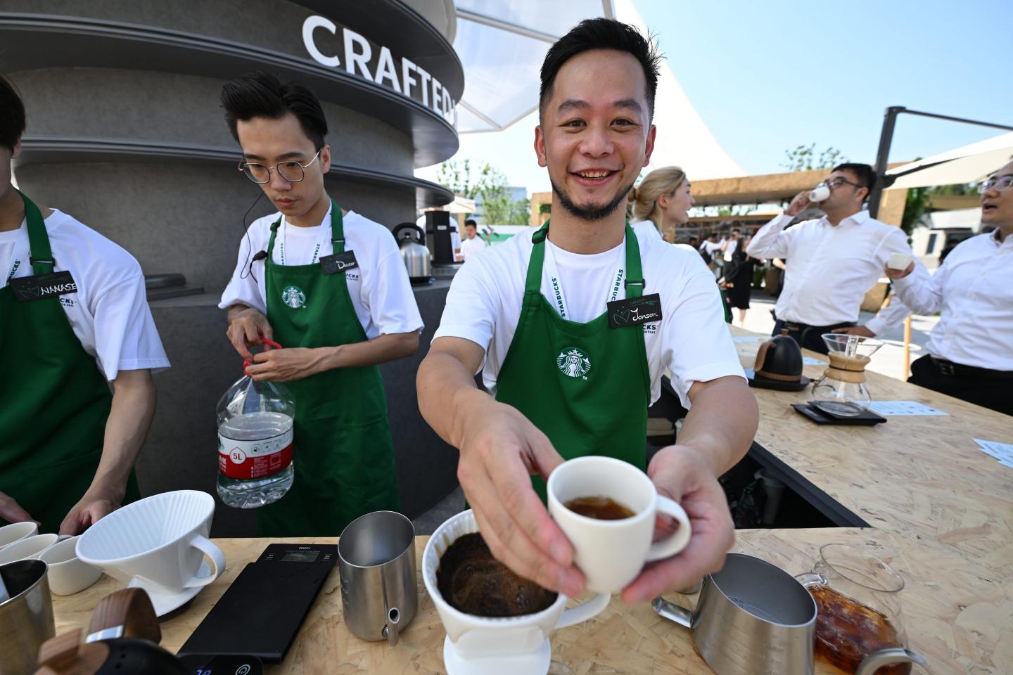 A Starbucks employee serving coffee