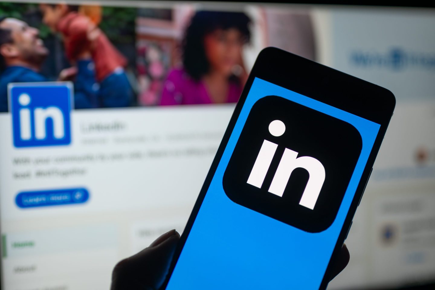 Phone in hand displaying LinkedIn's logo
