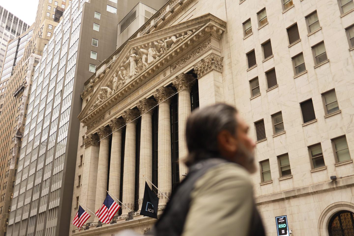 People walk past the New York Stock Exchange.