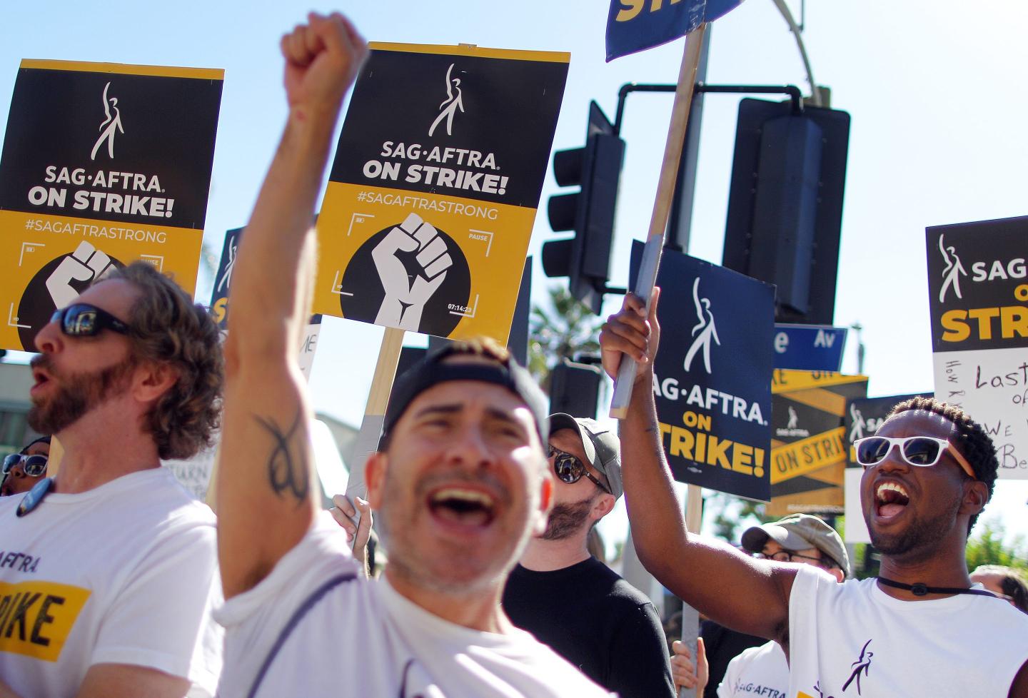 SAG-AFTRA members and supporters chant outside Paramount Studios